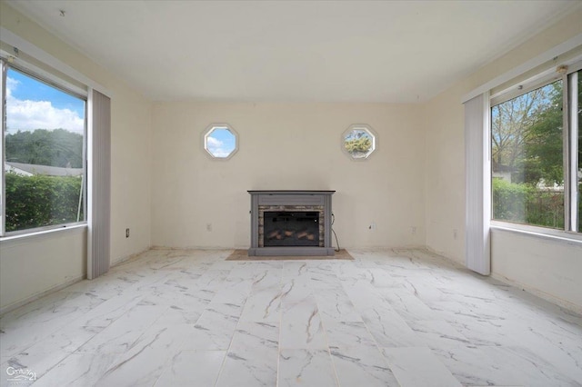 7003 Paige Ave, Warren, MI 48091 - unfurnished living room featuring healthy amount of natural light, marble look tile flooring, and a fireplace