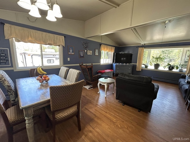 381 Mangum Rd, Marquette, MI 49855 - dining space featuring wood finished floors, a chandelier, vaulted ceiling, and a baseboard heating unit