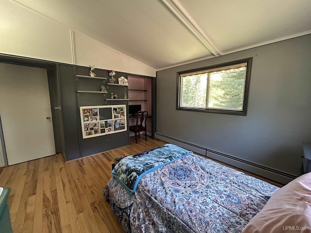381 Mangum Rd, Marquette, MI 49855 - bedroom featuring vaulted ceiling, a baseboard heating unit, and wood finished floors