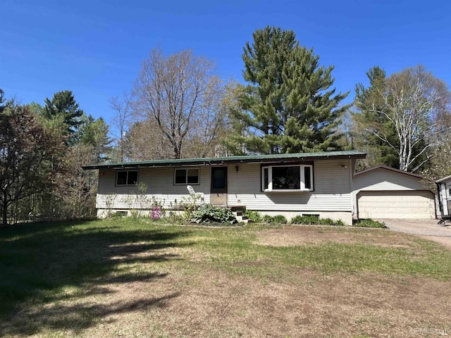 381 Mangum Rd, Marquette, MI 49855 - single story home with a front yard, an outdoor structure, and a garage