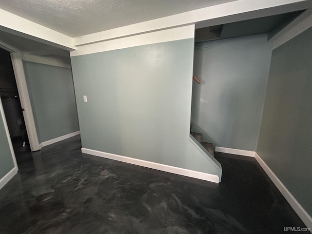 381 Mangum Rd, Marquette, MI 49855 - finished basement featuring baseboards, stairway, and a textured ceiling