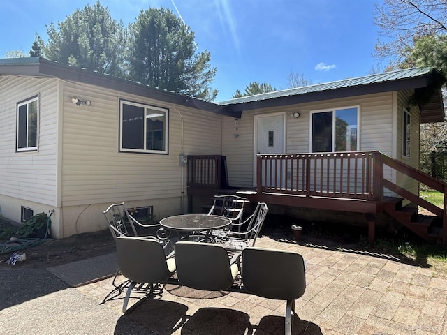 381 Mangum Rd, Marquette, MI 49855 - back of property featuring a patio area, outdoor dining space, metal roof, a deck, and crawl space