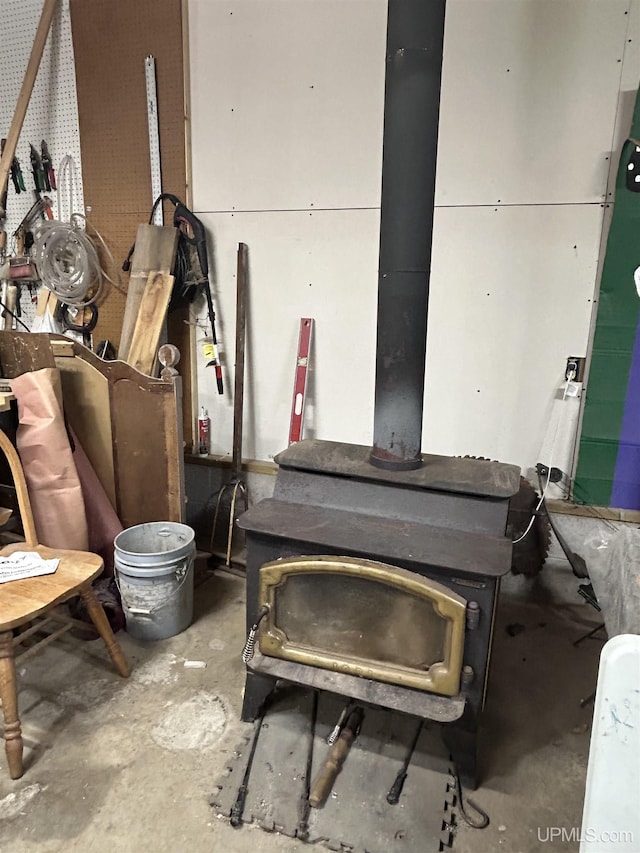 381 Mangum Rd, Marquette, MI 49855 - detailed view of unfinished concrete floors and a wood stove