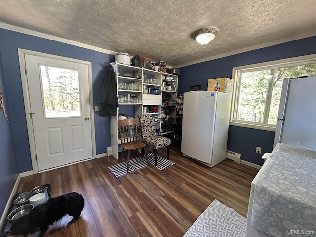 381 Mangum Rd, Marquette, MI 49855 - dining space with a textured ceiling, a baseboard radiator, wood finished floors, baseboards, and ornamental molding