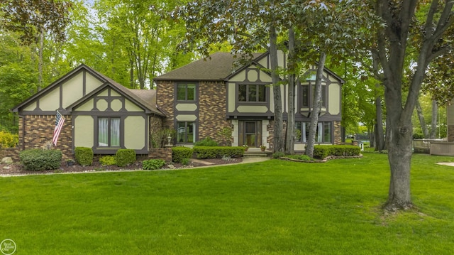 53638 Sherwood Ln, Shelby Twp, MI 48315 - english style home featuring a front lawn, brick siding, and stucco siding