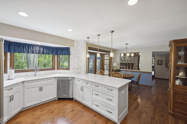 53638 Sherwood Ln, Shelby Twp, MI 48315 - kitchen featuring a sink, stainless steel dishwasher, a peninsula, light countertops, and white cabinets