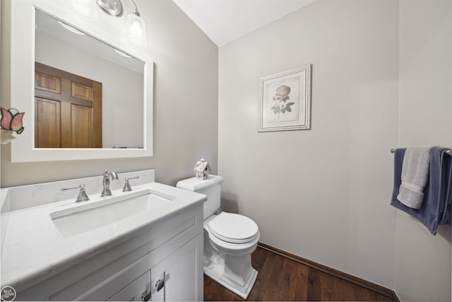 53638 Sherwood Ln, Shelby Twp, MI 48315 - half bathroom with wood finished floors, vanity, toilet, and baseboards