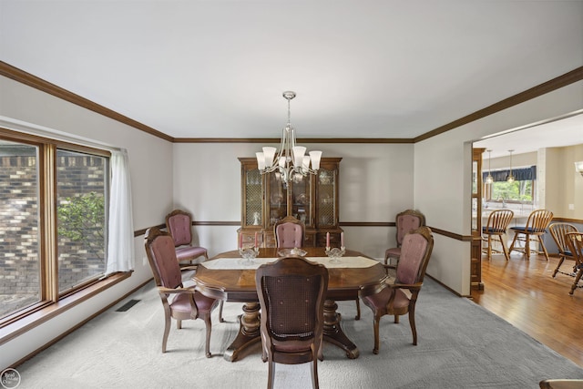 53638 Sherwood Ln, Shelby Twp, MI 48315 - dining space featuring a chandelier, wood finished floors, crown molding, and baseboards