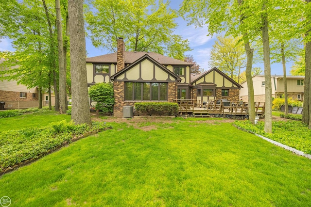 53638 Sherwood Ln, Shelby Twp, MI 48315 - rear view of property with a deck, a lawn, a chimney, and roof with shingles