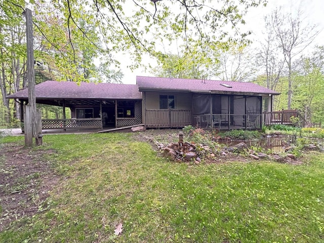 2913 W Howard Rd, Beaverton, MI 48612 - rear view of property featuring a yard, a deck, and a shingled roof