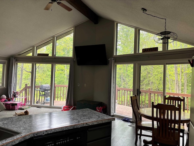 2913 W Howard Rd, Beaverton, MI 48612 - dining room featuring healthy amount of natural light, ceiling fan, beamed ceiling, high vaulted ceiling, and wood finished floors