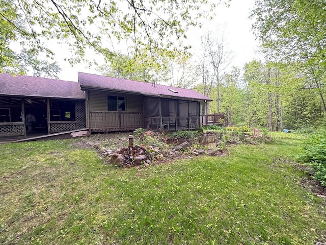 2913 W Howard Rd, Beaverton, MI 48612 - view of grassy yard with a sunroom and a wooden deck