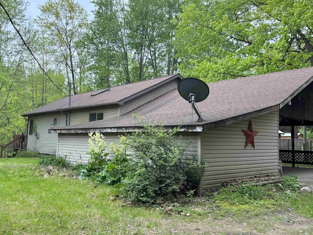 2913 W Howard Rd, Beaverton, MI 48612 - view of property exterior with a shingled roof and an attached carport