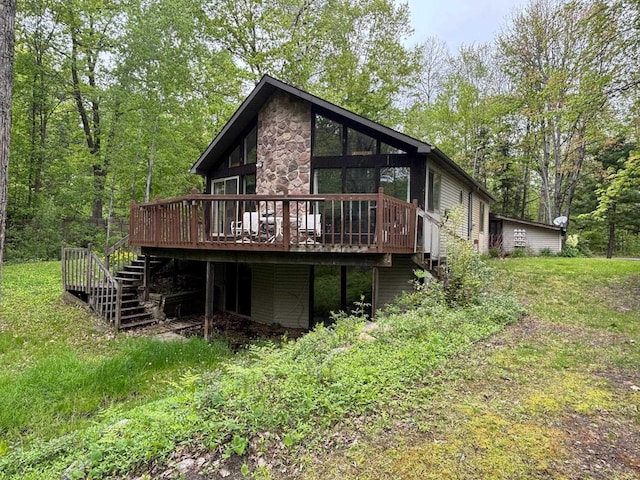 2913 W Howard Rd, Beaverton, MI 48612 - rear view of house featuring stairway, a deck, and stone siding