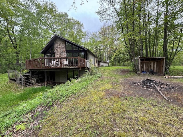 2913 W Howard Rd, Beaverton, MI 48612 - view of yard featuring a wooden deck, stairs, and a view of trees