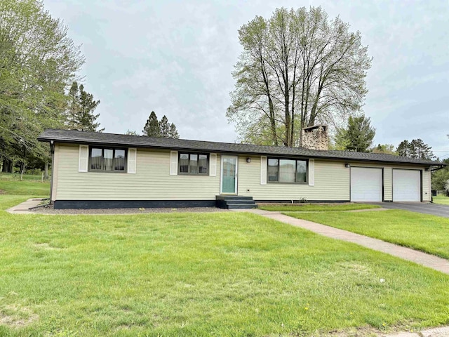 725 N Luxmore St, Ironwood, MI 49938 - view of front of house featuring driveway, a chimney, entry steps, a front lawn, and an attached garage
