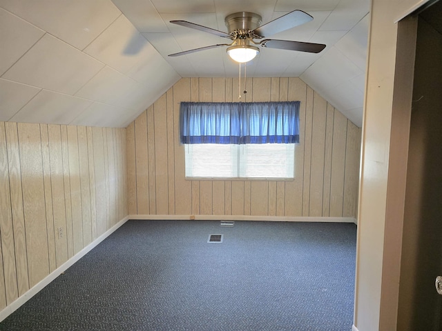 408 Sidney St, Bay City, MI 48706 - additional living space with wood walls, vaulted ceiling, a ceiling fan, carpet flooring, and baseboards