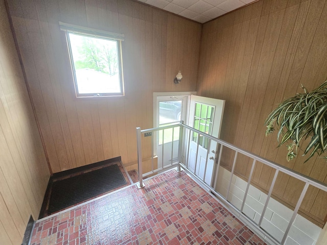 408 Sidney St, Bay City, MI 48706 - empty room with wood walls and brick patterned floors