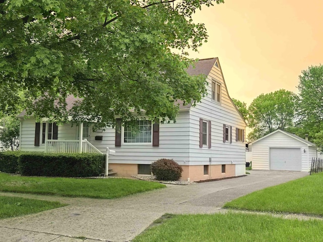 408 Sidney St, Bay City, MI 48706 - view of side of home featuring an outdoor structure, a garage, driveway, a porch, and a lawn