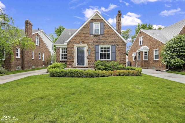 1873 Manchester Blvd, Grosse Pointe Woods, MI 48236 - view of front of property with a front lawn, a chimney, and brick siding
