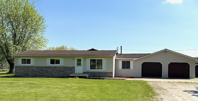 7161 W Sterling Rd, Sterling, MI 48659 - ranch-style house with stone siding, driveway, an attached garage, and a front lawn