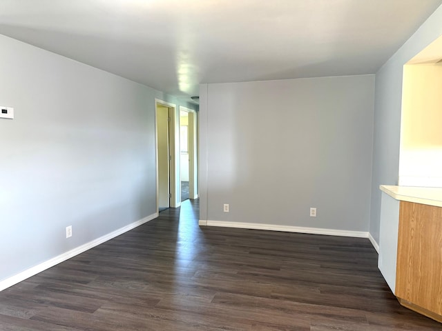 7161 W Sterling Rd, Sterling, MI 48659 - empty room with dark wood-style flooring and baseboards