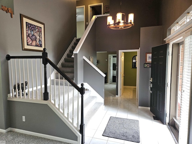 4324 Clear Creek Ct, Oakland Twp, MI 48306 - foyer entrance with a chandelier, baseboards, stairs, light tile patterned flooring, and a high ceiling