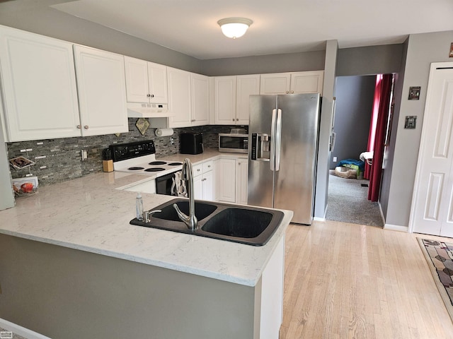 4324 Clear Creek Ct, Oakland Twp, MI 48306 - kitchen with appliances with stainless steel finishes, under cabinet range hood, a sink, light wood finished floors, and decorative backsplash