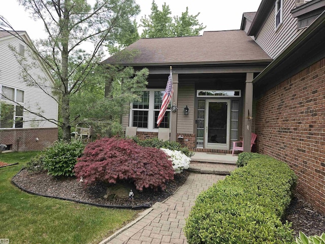 4324 Clear Creek Ct, Oakland Twp, MI 48306 - view of exterior entry with a porch, brick siding, and roof with shingles