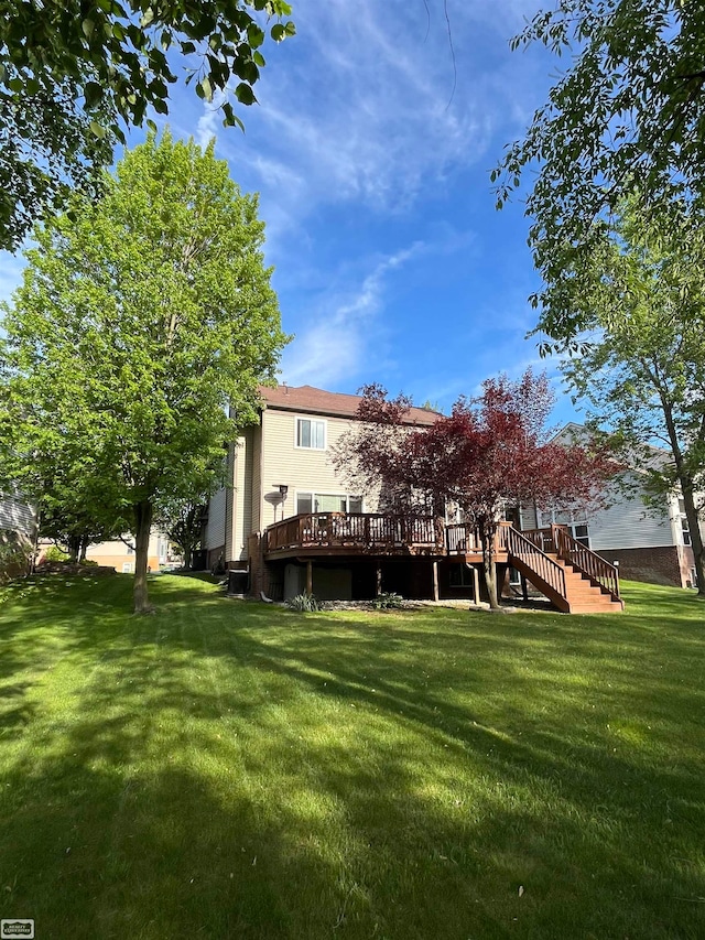 4324 Clear Creek Ct, Oakland Twp, MI 48306 - rear view of property with a deck, a lawn, and stairway