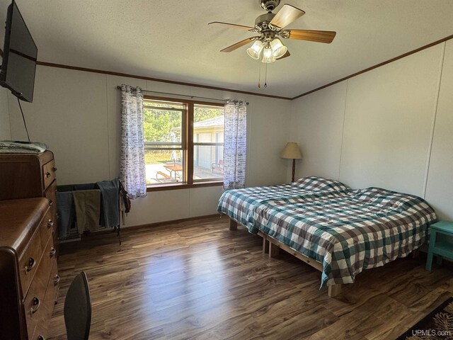 93 E Johnson Lake Rd, Gwinn, MI 49841 - bedroom featuring crown molding, wood finished floors, ceiling fan, and a decorative wall