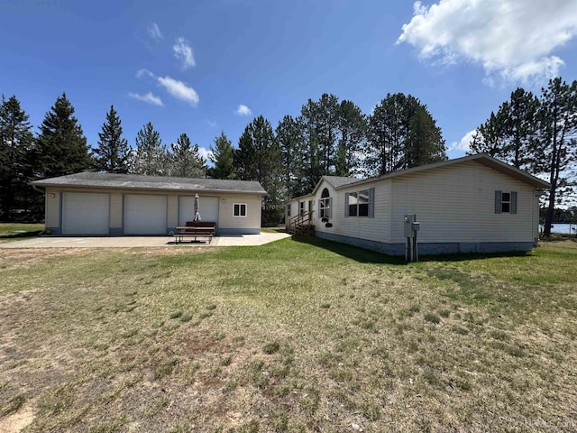 93 E Johnson Lake Rd, Gwinn, MI 49841 - rear view of house with a lawn, a garage, and an outdoor structure