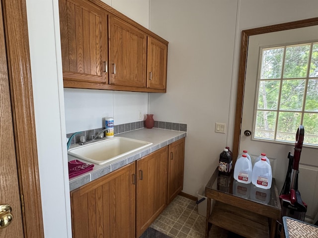 93 E Johnson Lake Rd, Gwinn, MI 49841 - kitchen with a sink, brown cabinets, and light countertops