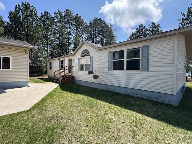 93 E Johnson Lake Rd, Gwinn, MI 49841 - view of front of house with a front lawn and a patio area