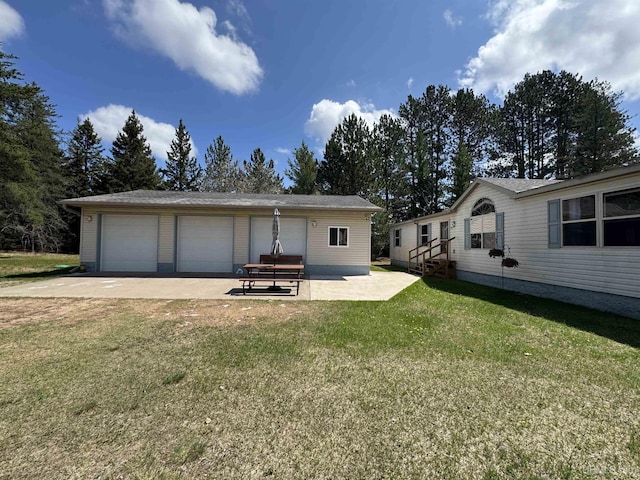 93 E Johnson Lake Rd, Gwinn, MI 49841 - rear view of house featuring a detached garage, an outdoor structure, and a lawn