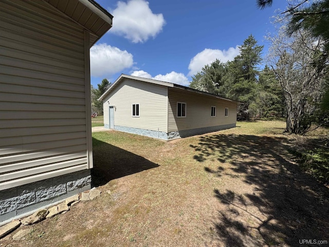 93 E Johnson Lake Rd, Gwinn, MI 49841 - view of home's exterior with a lawn