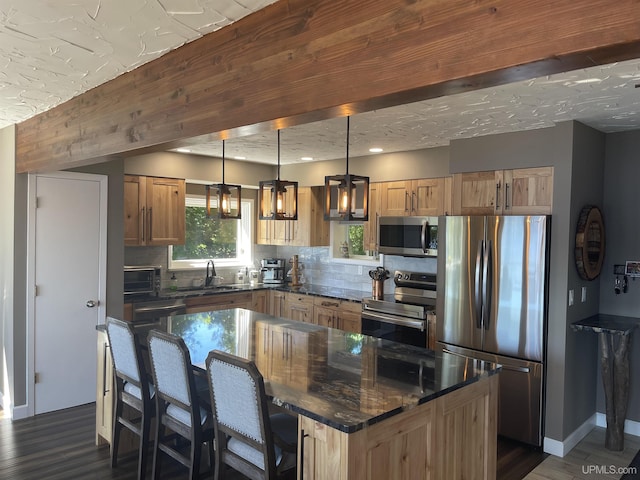 52170 Canal Rd, Houghton, MI 49931 - kitchen with stainless steel appliances, tasteful backsplash, a sink, dark wood-type flooring, and recessed lighting