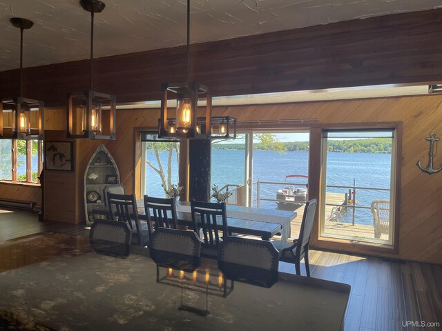 52170 Canal Rd, Houghton, MI 49931 - dining room featuring wood walls, a water view, a baseboard radiator, and wood finished floors