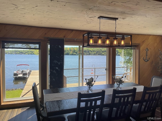 52170 Canal Rd, Houghton, MI 49931 - dining room with a water view, wood walls, and plenty of natural light