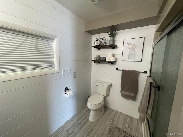 52170 Canal Rd, Houghton, MI 49931 - bathroom featuring toilet, a stall shower, and wood finished floors