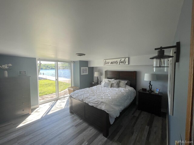 52170 Canal Rd, Houghton, MI 49931 - bedroom featuring access to exterior, expansive windows, and wood finished floors