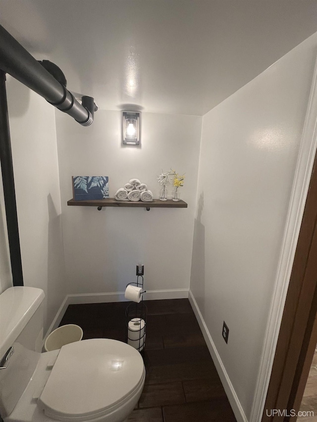 52170 Canal Rd, Houghton, MI 49931 - bathroom with toilet, baseboards, and wood finished floors