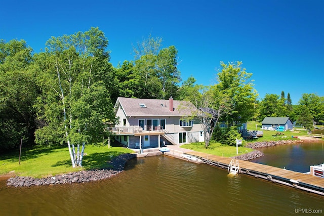52170 Canal Rd, Houghton, MI 49931 - back of property featuring a yard, stairs, a deck with water view, and a chimney