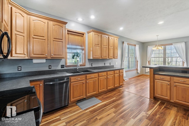 3275 Morrish Rd, Swartz Creek, MI 48473 - kitchen featuring stainless steel dishwasher, a sink, wood finished floors, a chandelier, and dark countertops