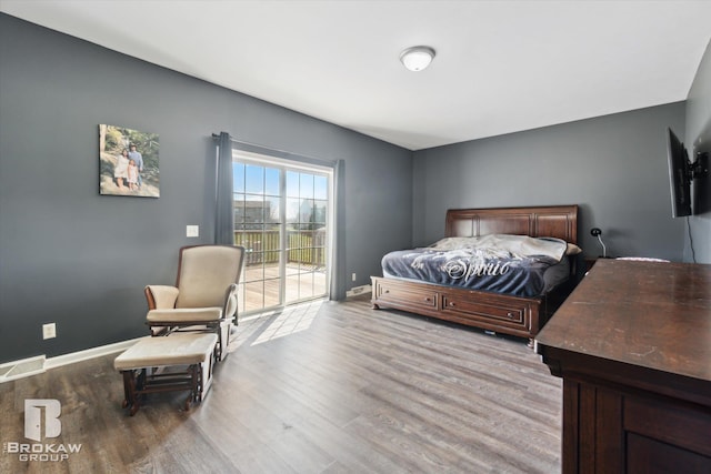 3275 Morrish Rd, Swartz Creek, MI 48473 - bedroom featuring access to exterior, wood finished floors, and baseboards