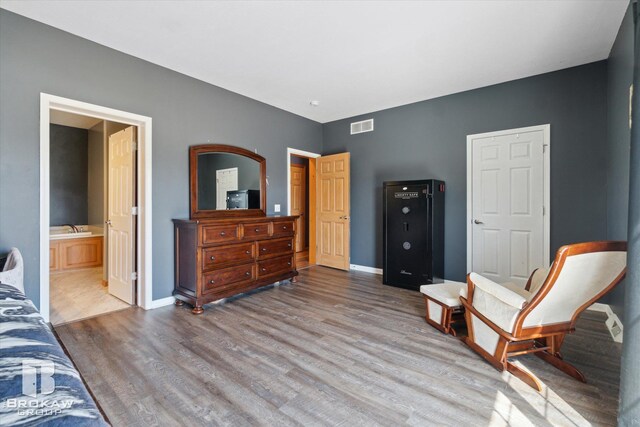 3275 Morrish Rd, Swartz Creek, MI 48473 - bedroom featuring wood finished floors, baseboards, and ensuite bathroom