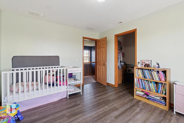 3275 Morrish Rd, Swartz Creek, MI 48473 - bedroom with wood finished floors, a walk in closet, and a closet