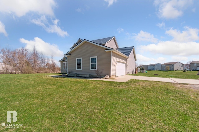 3275 Morrish Rd, Swartz Creek, MI 48473 - view of property exterior featuring driveway, a lawn, a garage, and metal roof