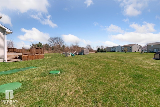3275 Morrish Rd, Swartz Creek, MI 48473 - view of green lawn with a wooden deck