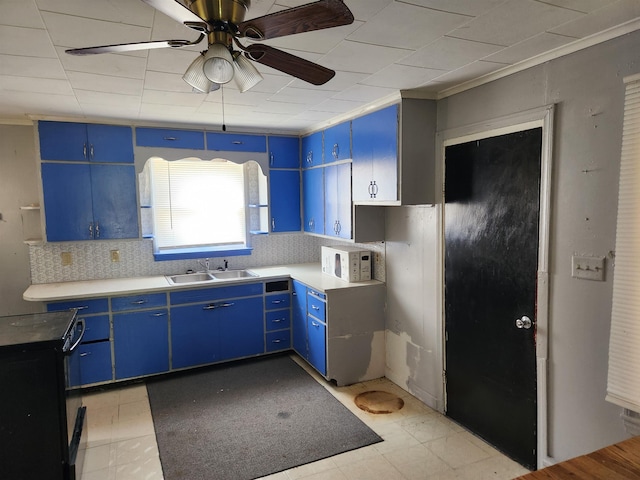 4680 E Kent Rd, Freeland, MI 48623 - kitchen featuring blue cabinets, a sink, white microwave, and ornamental molding